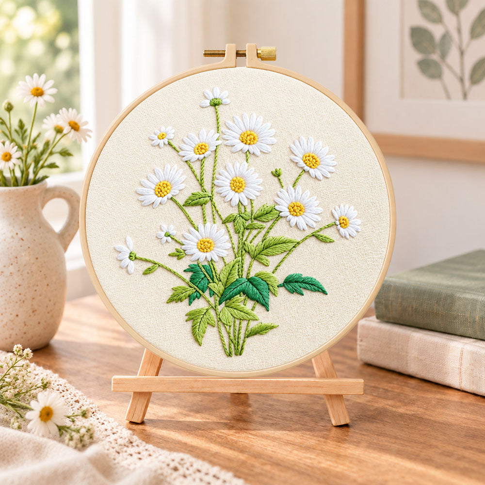 Daisies on beige background embroidery kit finished hoop displayed on a wooden stand as cozy tabletop decor