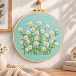 Daisies on teal fabric embroidery hoop wall art displayed as warm and cozy handmade home decor