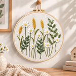 Daisy and wheat embroidery hoop wall art displayed as warm and cozy handmade home decor