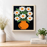 Finished daisy flowers in orange vase artwork displayed on a wall