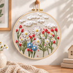 Daisy garden with clouds embroidery hoop wall art displayed as warm and cozy handmade home decor