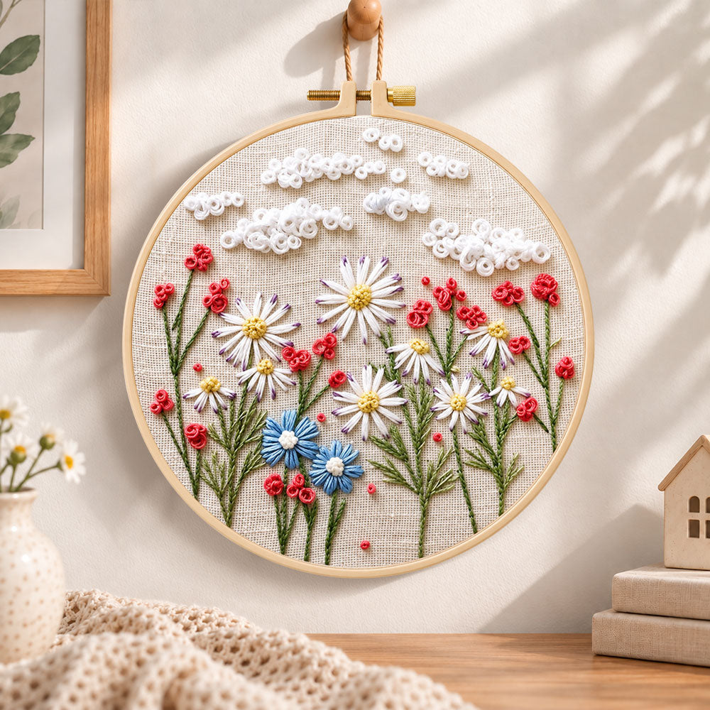 Daisy garden with clouds embroidery hoop wall art displayed as warm and cozy handmade home decor