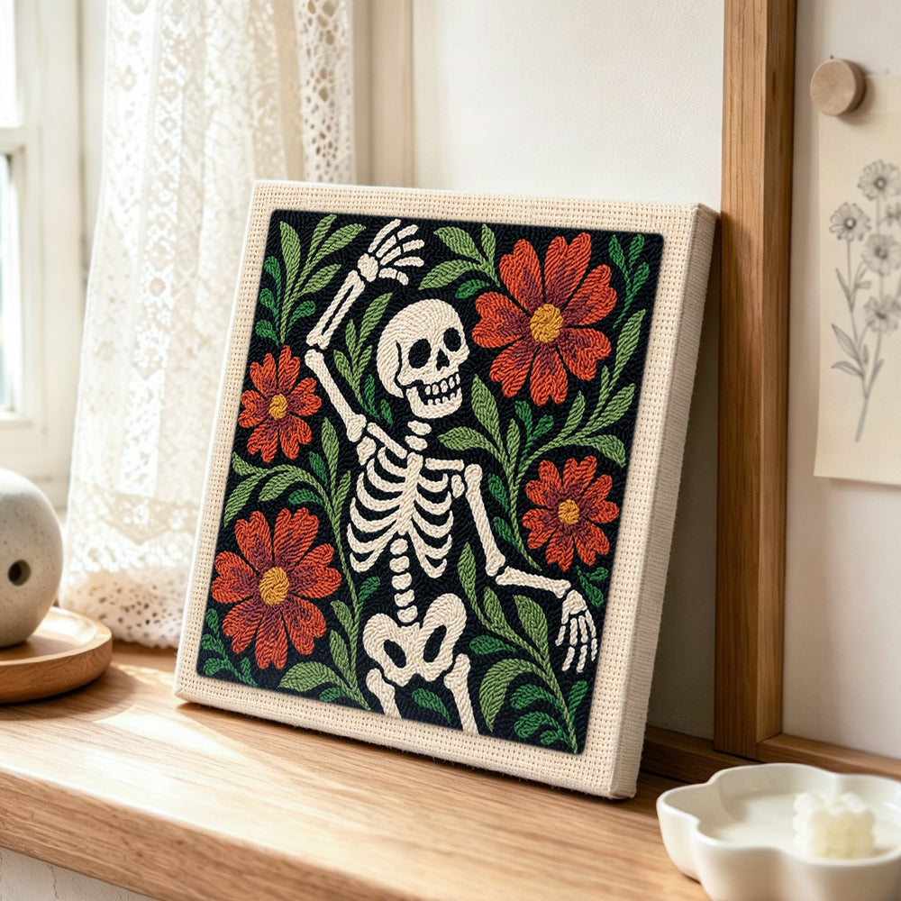 Dancing floral skeleton punch needle artwork displayed on a table