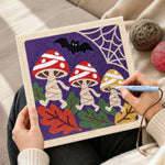 Creating handmade dancing halloween mushrooms punch needle artwork