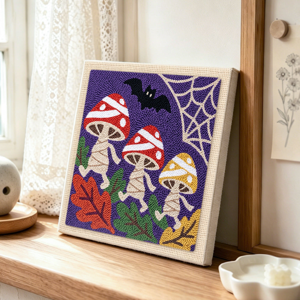 Dancing halloween mushrooms punch needle artwork displayed on a table