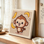 Dancing monkey with flying bananas punch needle artwork displayed on a table