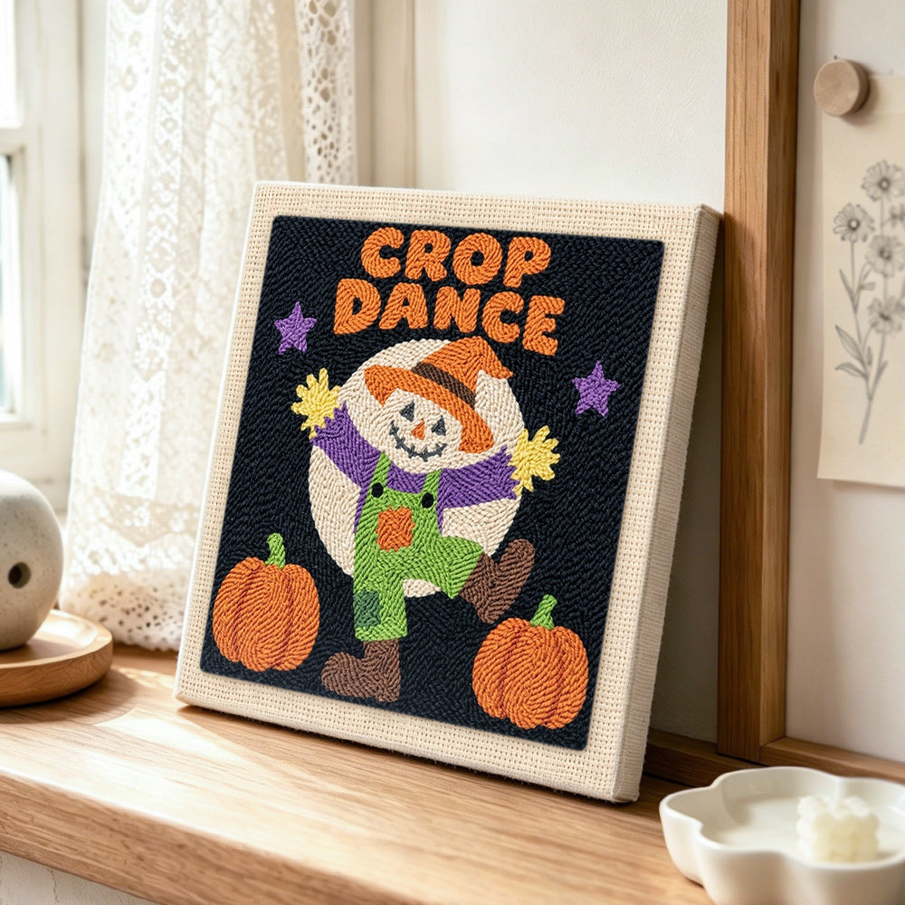 Dancing scarecrow under moon punch needle artwork displayed on a table
