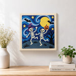 Finished dancing skeletons under moon artwork displayed on a wall