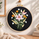 Dark background lilies embroidery hoop wall art displayed as warm and cozy handmade home decor