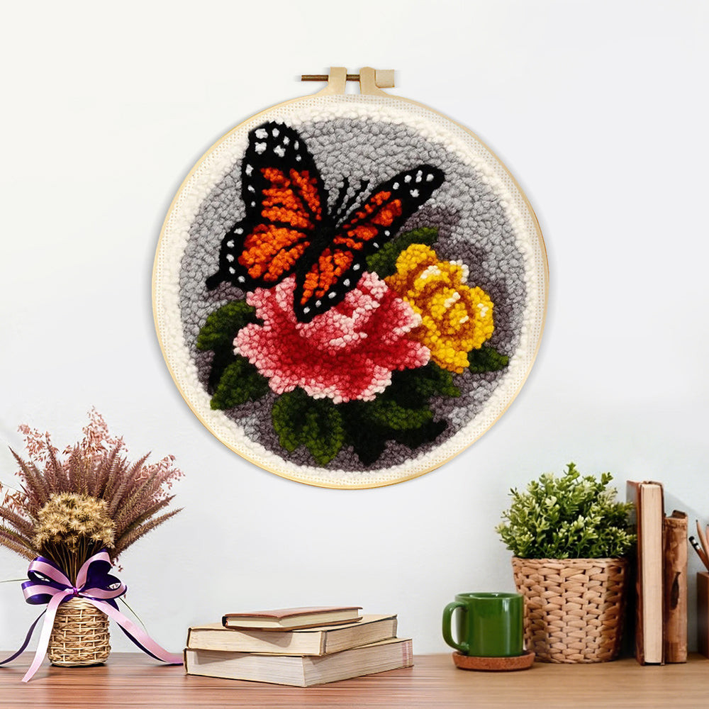 Finished dark-colored butterfly and flowers artwork displayed on a wall