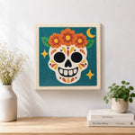 Finished day of dead floral skull artwork displayed on a wall