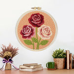 Finished deep pink and cream roses artwork displayed on a wall