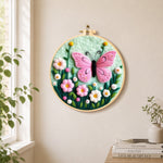 Delicate pink butterfly and flowers needle felt wall art displayed in a bright home interior