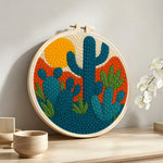 Desert cactus punch needle artwork displayed on a table