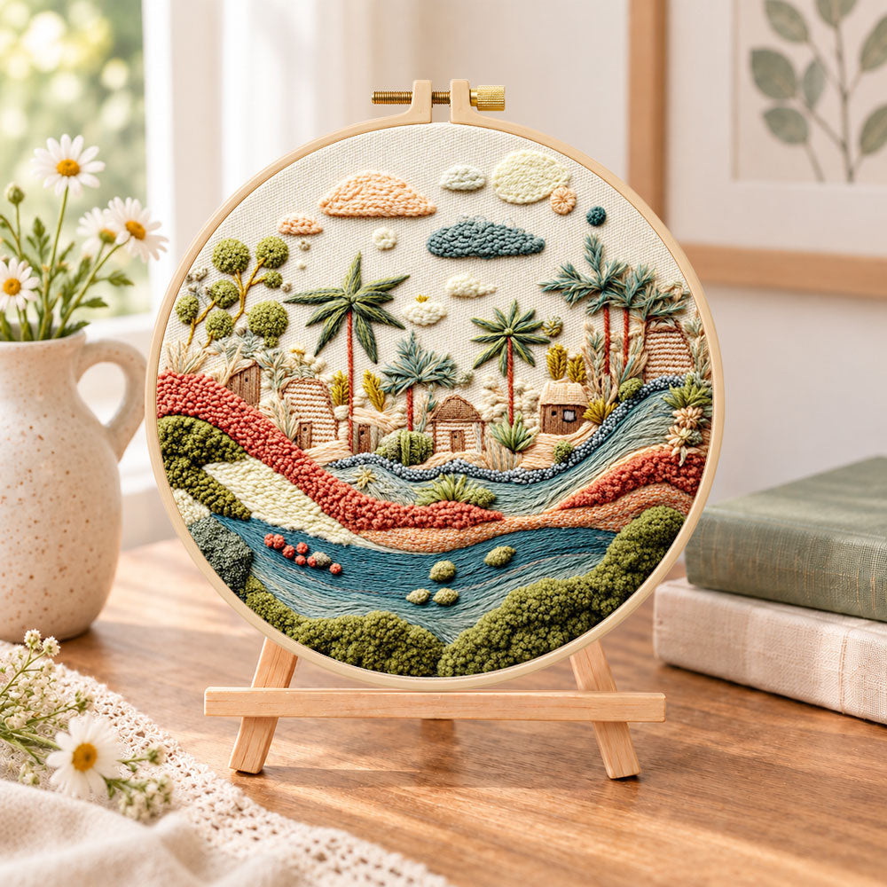 Desert stream hamlet embroidery kit finished hoop displayed on a wooden stand as cozy tabletop decor