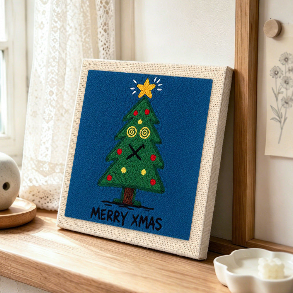 Dizzy eyes xmas tree punch needle artwork displayed on a table