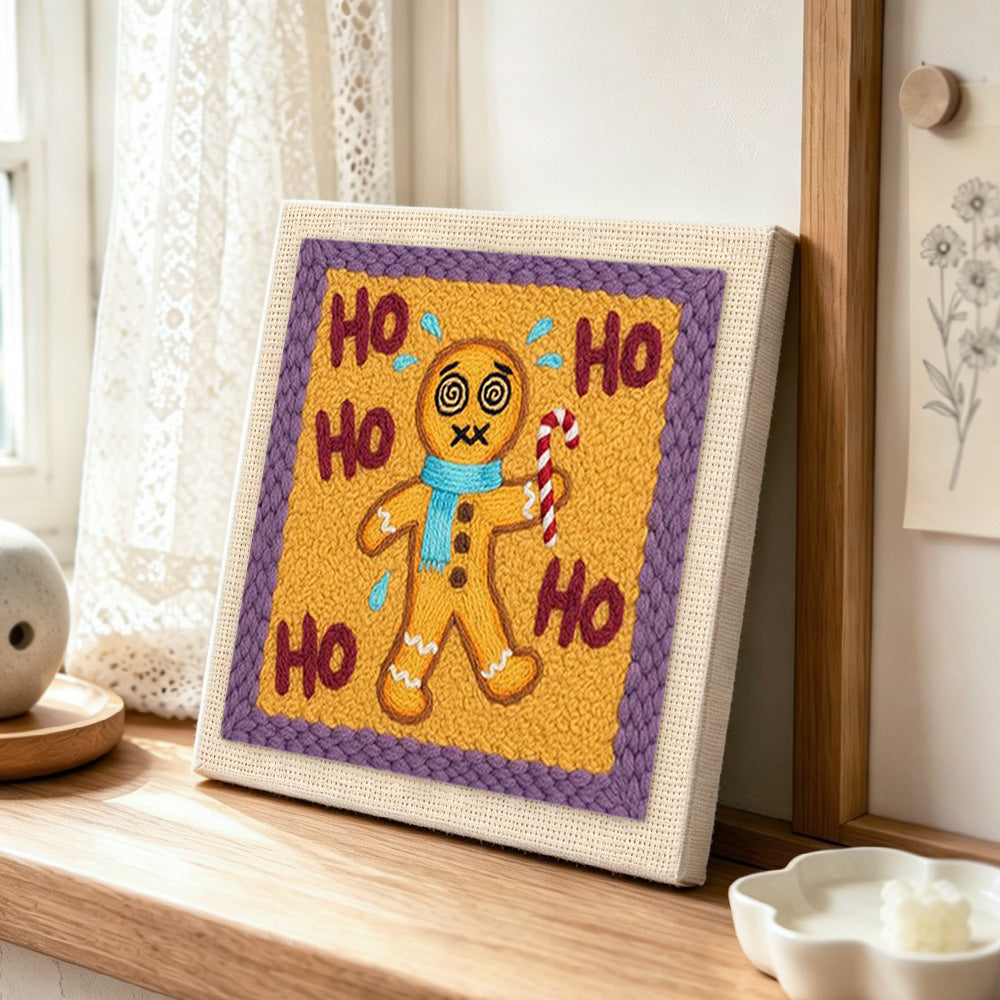 Dizzy gingerbread man punch needle artwork displayed on a table