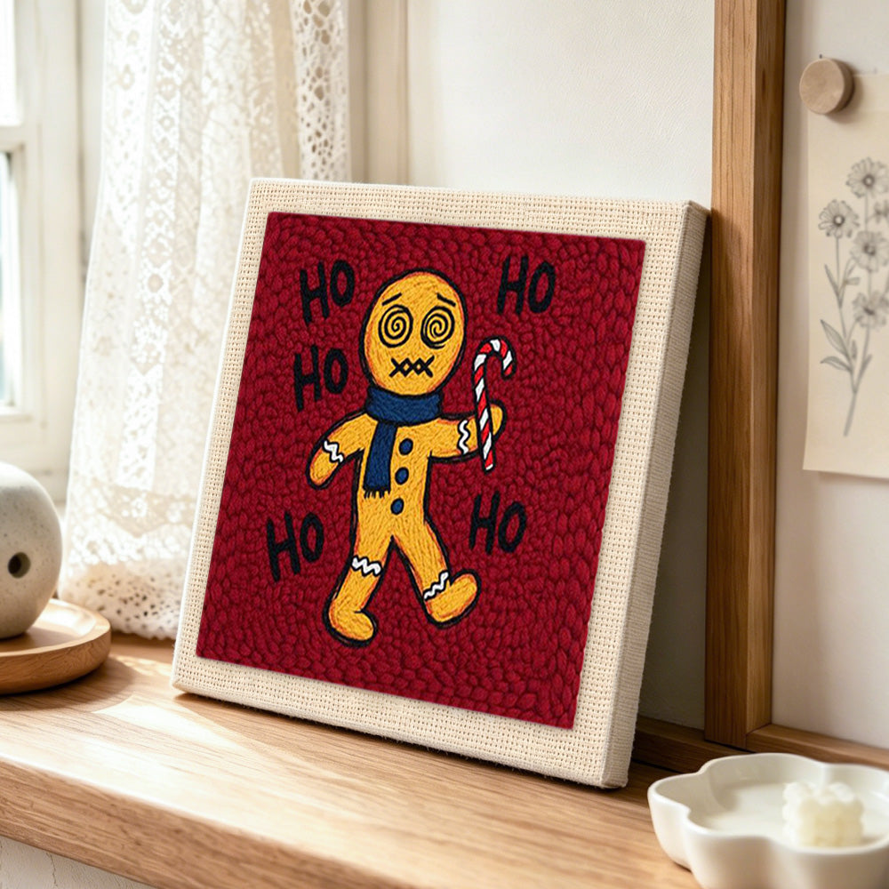 Dizzy gingerbread man with candy cane punch needle artwork displayed on a table