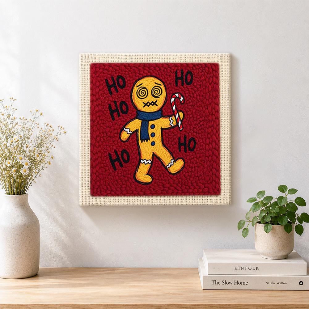 Finished dizzy gingerbread man with candy cane artwork displayed on a wall