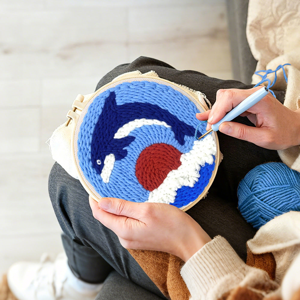 Creating handmade dolphin at sunset punch needle artwork