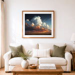 Finished dramatic sunset cumulus clouds cross stitch artwork displayed as home decor
