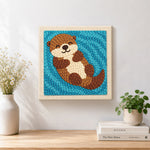 Finished dreamy swimming otter artwork displayed on a wall