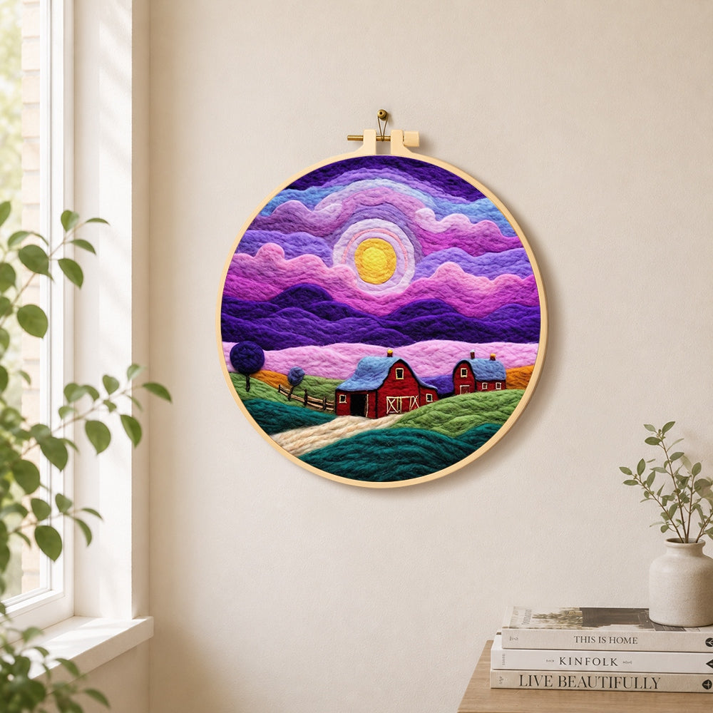Dreamy swirling purple sky and red barn needle felt wall art displayed in a bright home interior