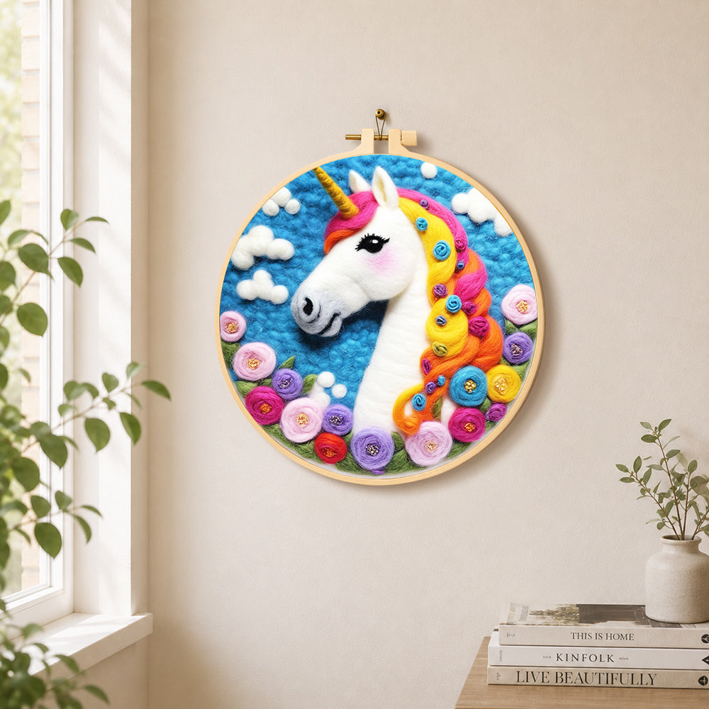 Dreamy unicorn and flowers needle felt wall art displayed in a bright home interior