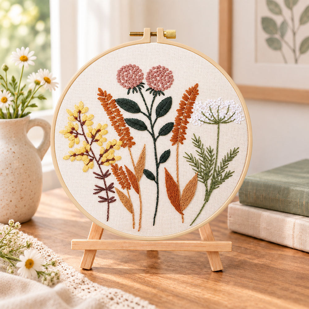 Dried wild florals embroidery kit finished hoop displayed on a wooden stand as cozy tabletop decor