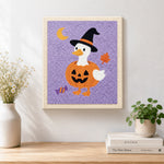Finished duck in pumpkin witch outfit artwork displayed on a wall