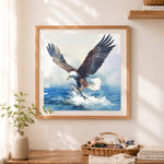 Finished dynamic bald eagle fishing cross stitch artwork displayed as home decor