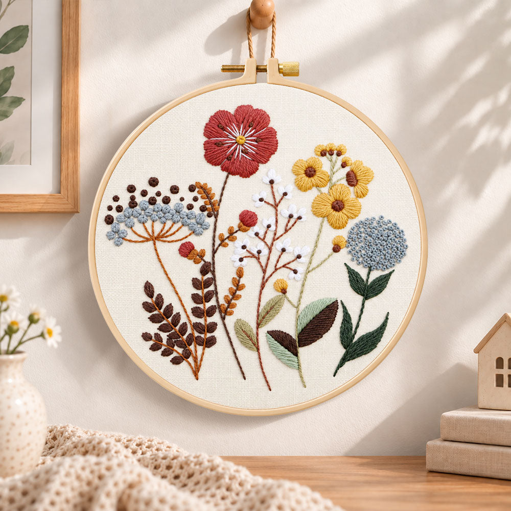 Earthy tone flora embroidery hoop wall art displayed as warm and cozy handmade home decor