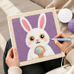 Creating handmade easter bunny with egg basket punch needle artwork