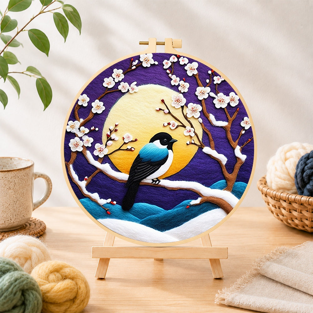 Finished elegant blue bird on snowy plum branch needle felting displayed on a wooden easel