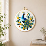 Elegant blue peacock needle felt wall art displayed in a bright home interior