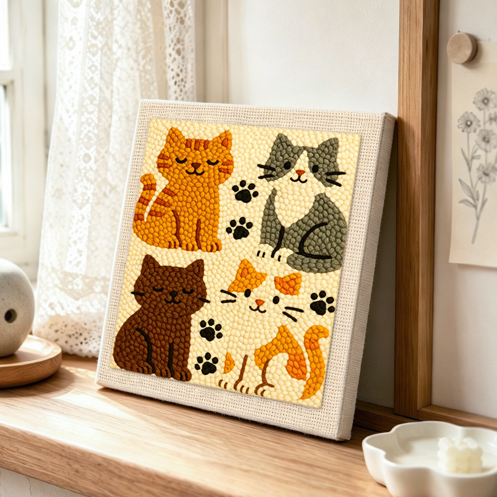 Elegant four cats and paw prints punch needle artwork displayed on a table
