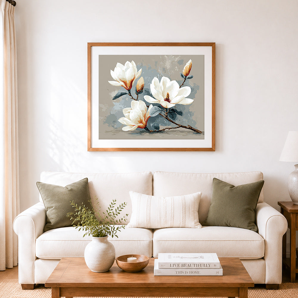 Finished elegant magnolia blooms cross stitch artwork displayed as home decor