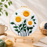 Finished elegant white daisies with yellow stamens needle felting displayed on a wooden easel