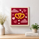 Finished entwined yellow hearts artwork displayed on a wall
