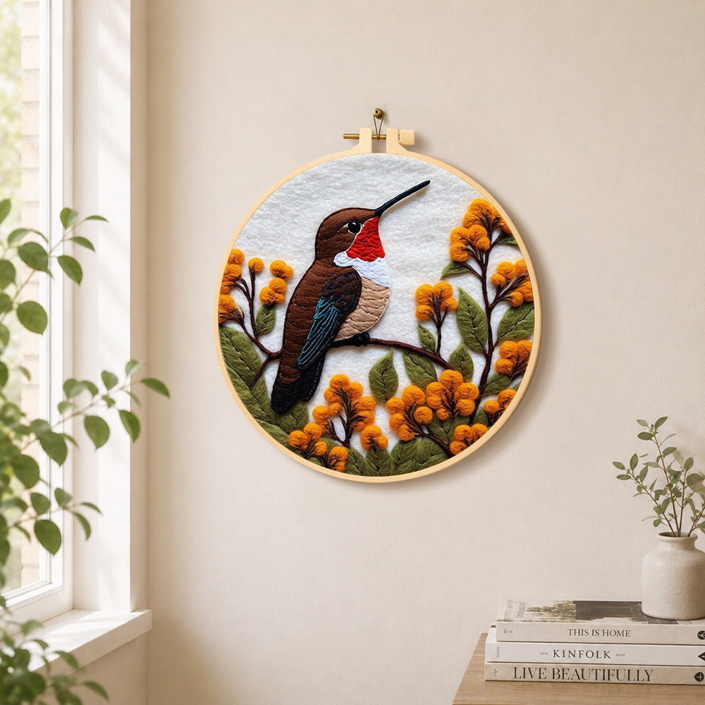 Exquisite ruby throated hummingbird and autumn flowers needle felt wall art displayed in a bright home interior