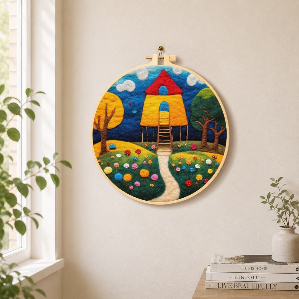 Fairy tale tall red roof cottage needle felt wall art displayed in a bright home interior