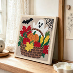 Fall harvest basket punch needle artwork displayed on a table