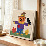 Fall pumpkin scarecrow punch needle artwork displayed on a table