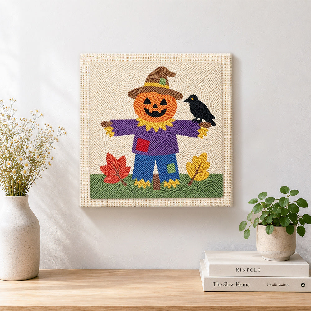 Finished fall pumpkin scarecrow artwork displayed on a wall