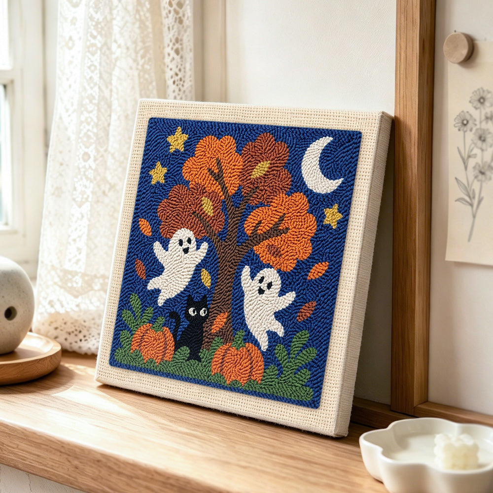 Fall tree ghosts punch needle artwork displayed on a table