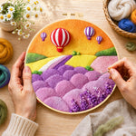 Creating the fantasy hot air balloon tour and pastel hills wool painting by hand with a felting needle