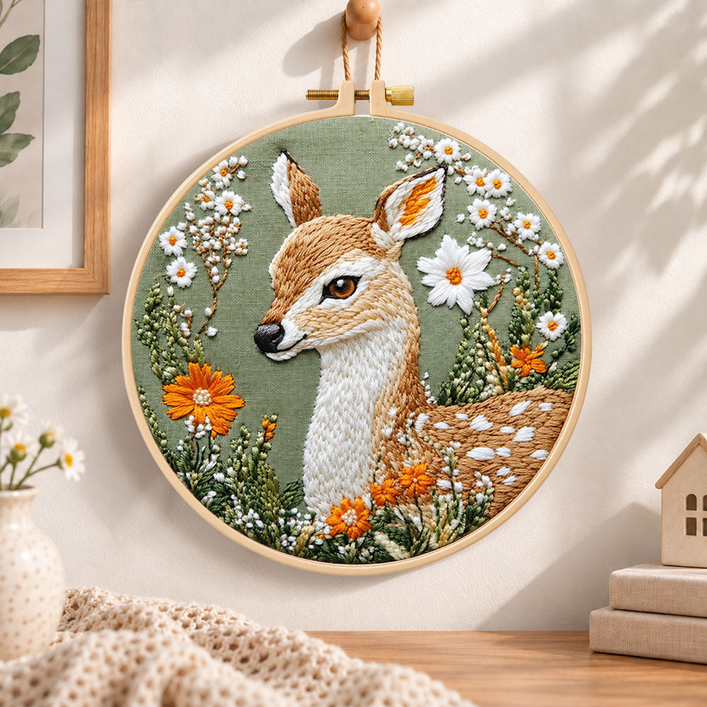 Fawn with daisies and orange blooms embroidery hoop wall art displayed as warm and cozy handmade home decor