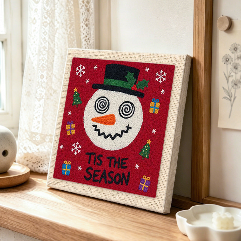 Festive snowman with gifts punch needle artwork displayed on a table