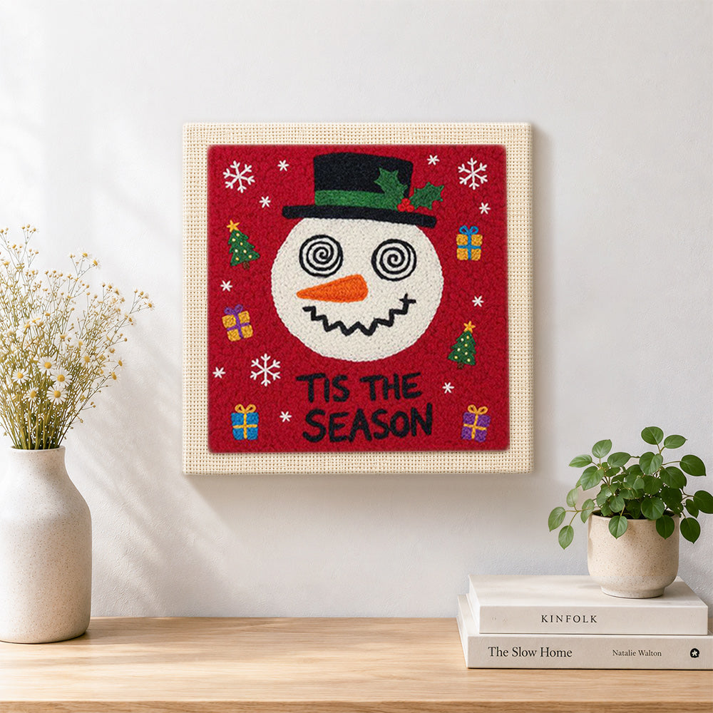 Finished festive snowman with gifts artwork displayed on a wall