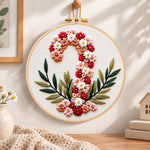 Floral candy cane design embroidery hoop wall art displayed as warm and cozy handmade home decor